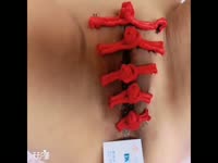 Weird bdsm fetish movie features girl using her piercing holes to tie her pussy lips together